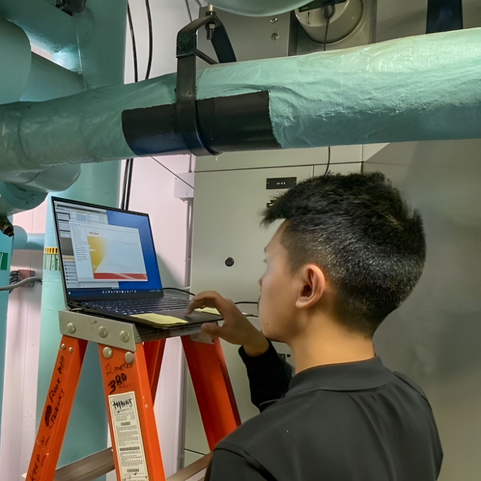 Photograph of utiliVisor employee performing meter diagnostics on-site